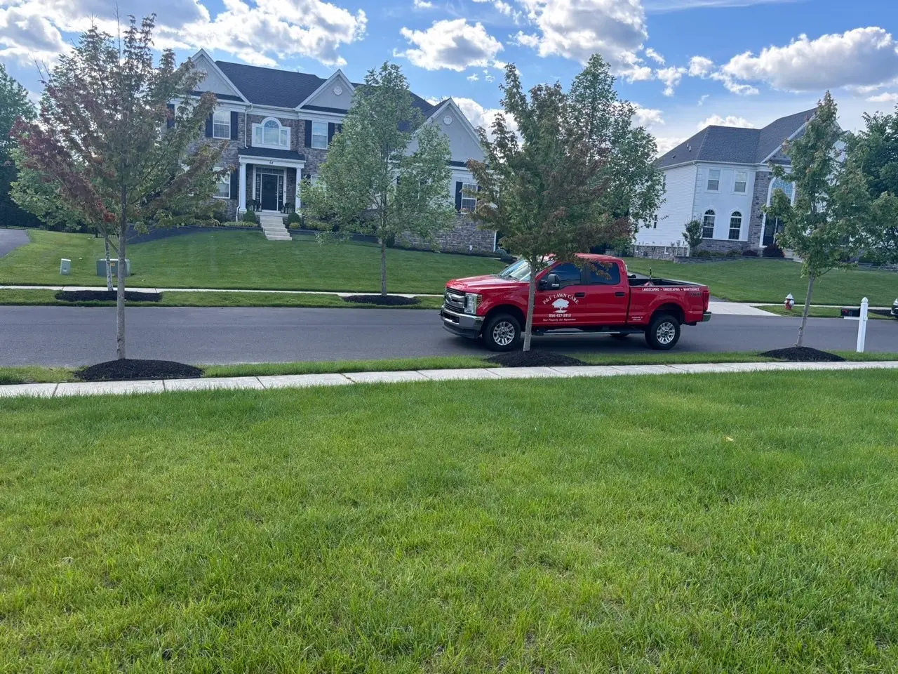 P&F Lawn Care truck on the job in a South Jersey neighborhood